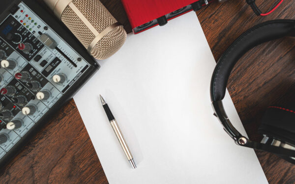 Pen and paper with microphone and headphones