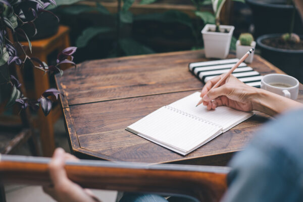 Writing Lyrics with guitar, pen and notebook