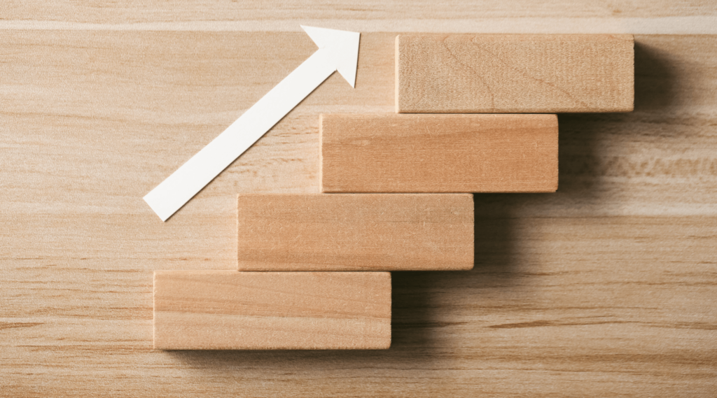 Wood blocks with arrow going up like steps