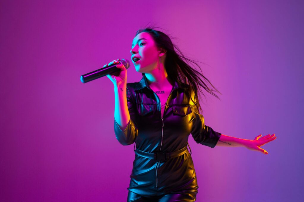 Female vocal artist singing into a microphone