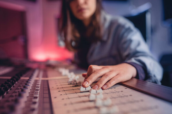female music artist using mix board