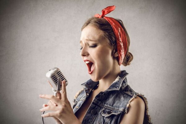 female vocal artist singing high notes