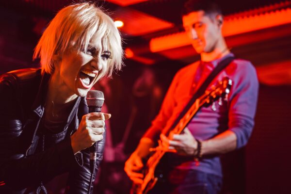 female vocal artist singing into a mic