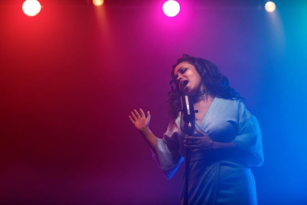 female vocal artist performing in the spotlight