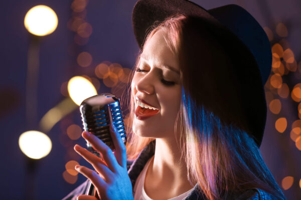 female vocal artist singing into a microphone